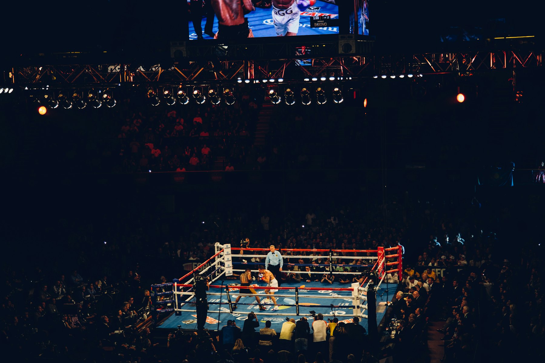 Boxer inside a ring during a dramatic fight night under bright spotlights
