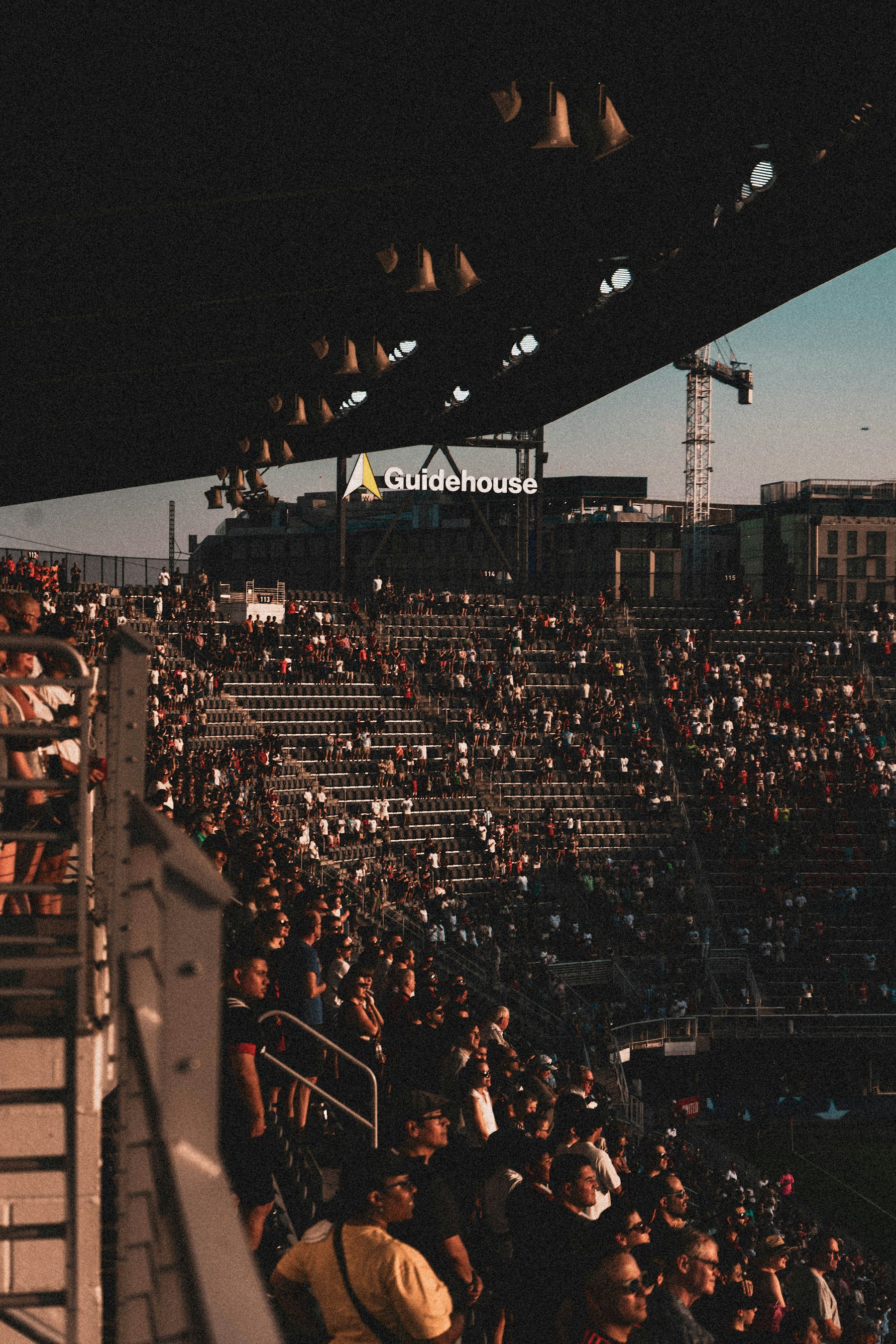 American football stadium packed with fans on a bright weekend afternoon